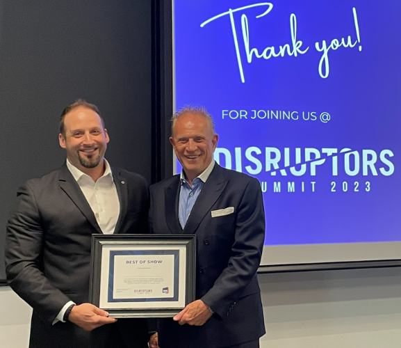 From left to right: Ash Andrews, Innovation Leader at Winpak Division receiving “Best of Show” award from Jim D. Downham, President & CEO of PAC Global